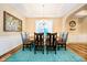 Bright dining room with a chandelier, large windows, hardwood floors, and wainscoting at 15506 Slateford Rd, Noblesville, IN 46062