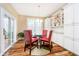 Dining room with glass table and red chairs has custom cabinets and lots of natural light at 15506 Slateford Rd, Noblesville, IN 46062