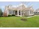 A beautiful home with stone accents, a well-kept lawn, and mature trees offering a welcoming presence at 15506 Slateford Rd, Noblesville, IN 46062