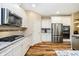 The kitchen features stainless steel appliances, white cabinets, and granite countertops at 15506 Slateford Rd, Noblesville, IN 46062