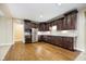 Spacious kitchen with dark cabinets, stainless steel appliances, and sleek granite countertops at 15506 Slateford Rd, Noblesville, IN 46062