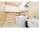 Functional laundry room with white cabinets, modern washer and dryer, and a utility sink at 15506 Slateford Rd, Noblesville, IN 46062