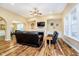 Cozy living room features wood floors, a fireplace, and arched doorway to dining room at 15506 Slateford Rd, Noblesville, IN 46062