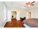 Spacious main bedroom with tray ceiling, hardwood floors and ensuite bathroom and kitchenette access at 15506 Slateford Rd, Noblesville, IN 46062