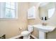 Powder room with pedestal sink, decorative mirror, and stylish fixtures for guests at 15506 Slateford Rd, Noblesville, IN 46062