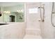 Walk-in shower with bench, tiled walls, and updated fixtures for a luxurious experience at 15506 Slateford Rd, Noblesville, IN 46062
