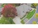 Aerial view featuring the home's roof, large driveway, mature trees, and meticulously maintained landscaping at 1738 Pathway S Dr, Greenwood, IN 46143