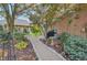A charming backyard features a stone path, seating area, lush landscaping, and mature trees at 1738 Pathway S Dr, Greenwood, IN 46143