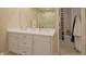 Bright bathroom features a double sink vanity, large mirror, and glass shower at 1738 Pathway S Dr, Greenwood, IN 46143