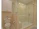 Bathroom boasts a glass enclosed shower, toilet and upper cabinet storage at 1738 Pathway S Dr, Greenwood, IN 46143