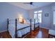 Bedroom features two twin beds, hardwood floors, ceiling fan and natural light at 1738 Pathway S Dr, Greenwood, IN 46143