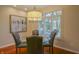 Cozy dining area features a modern chandelier, seating for four, and lovely natural light from the window at 1738 Pathway S Dr, Greenwood, IN 46143