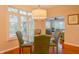 Stylish dining area offering natural light, an elegant chandelier, and comfortable seating for four at 1738 Pathway S Dr, Greenwood, IN 46143
