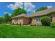 Beautiful brick home with a lush green lawn, manicured landscaping, and a welcoming exterior at 1738 Pathway S Dr, Greenwood, IN 46143