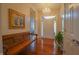 Inviting foyer featuring hardwood floors, chandelier, decorative mirror, and a stylish wooden bench at 1738 Pathway S Dr, Greenwood, IN 46143