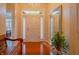 Elegant foyer with hardwood floors, chandelier, decorative mirror, and charming wooden bench seating at 1738 Pathway S Dr, Greenwood, IN 46143