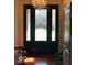 Elegant foyer with a decorative chandelier, glass paneled front door, and hardwood flooring at 1738 Pathway S Dr, Greenwood, IN 46143