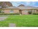 Charming brick home with lush green lawn and landscaped front yard showcasing the inviting exterior at 1738 Pathway S Dr, Greenwood, IN 46143
