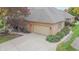 Spacious garage with ample parking space and an extended driveway, set in a serene landscape at 1738 Pathway S Dr, Greenwood, IN 46143