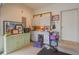 Well lit garage features upper cabinets, storage and access to exterior door at 1738 Pathway S Dr, Greenwood, IN 46143