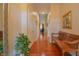 Hallway with beautiful hardwood floors, decorative mirror, wooden bench, and neutral paint at 1738 Pathway S Dr, Greenwood, IN 46143