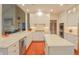 Gourmet kitchen featuring white cabinets, stainless steel appliances, island with stone counters, and eat-in bar at 1738 Pathway S Dr, Greenwood, IN 46143