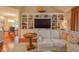 Comfortable living room with built-in bookshelves and adjoining dining room at 1738 Pathway S Dr, Greenwood, IN 46143