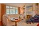 Cozy living room with a fireplace, built-in shelving, and large windows at 1738 Pathway S Dr, Greenwood, IN 46143