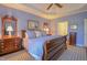 Comfortable main bedroom includes a plush bed, classic dressers, and a well-lit, relaxing atmosphere at 1738 Pathway S Dr, Greenwood, IN 46143