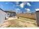 View of the backyard with a patio with furniture and a fire pit area, all surrounded by a wooden privacy fence at 1828 Central Ave, Columbus, IN 47201