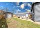 Inviting backyard features a metal storage shed, patio area, and a fenced yard at 1828 Central Ave, Columbus, IN 47201