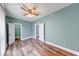 Spacious bedroom with neutral paint, modern ceiling fan, and wood-look flooring at 1828 Central Ave, Columbus, IN 47201