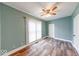 Bedroom features wood-look flooring, neutral paint and a ceiling fan at 1828 Central Ave, Columbus, IN 47201