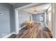 Open-concept dining room with hardwood floors, neutral paint, and views into the kitchen at 1828 Central Ave, Columbus, IN 47201
