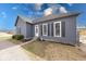 Exterior view of home with gray painted wood, dark shutters, and a gravel front yard at 1828 Central Ave, Columbus, IN 47201