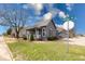 Charming single-story home with a well-maintained lawn and a welcoming front porch on a sunny day at 1828 Central Ave, Columbus, IN 47201