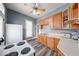 A kitchen boasts wood cabinets, durable countertops, stainless steel sink, and wood grain flooring at 1828 Central Ave, Columbus, IN 47201