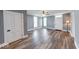 Spacious living room with hardwood floors, fresh paint, and abundant natural light streaming through the windows at 1828 Central Ave, Columbus, IN 47201