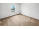 Bright bedroom with neutral carpet, white walls, and large window offering serene outdoor views at 1914 Kingen Dr, Greenfield, IN 46140