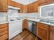 Efficient kitchen featuring light wood cabinets, white appliances, and durable laminate countertops at 1914 Kingen Dr, Greenfield, IN 46140