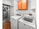 Functional laundry room with washer, dryer, furnace, cabinet, and wood-look flooring at 1914 Kingen Dr, Greenfield, IN 46140