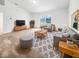 Bright living room with neutral tones, plush rug, and ample seating for comfortable relaxation at 1914 Kingen Dr, Greenfield, IN 46140