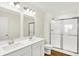 Bathroom boasts a double vanity, walk-in shower and modern finishes at 19599 Atwater Ave, Sheridan, IN 46069