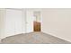 Carpeted bedroom featuring a closet and view into the kitchen at 19599 Atwater Ave, Sheridan, IN 46069