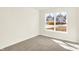 Well-lit bedroom showcasing a large window and neutral carpeting at 19599 Atwater Ave, Sheridan, IN 46069