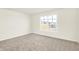 Bright bedroom features a large window with neighborhood views and plush carpeting at 19599 Atwater Ave, Sheridan, IN 46069