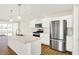 Kitchen featuring stainless steel appliances, a kitchen island, and white cabinetry at 19599 Atwater Ave, Sheridan, IN 46069