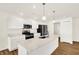 Modern kitchen with white cabinets, stainless steel appliances, and an island sink at 19599 Atwater Ave, Sheridan, IN 46069