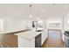 Open-concept kitchen with quartz counters, stainless appliances, and hardwood floors at 19599 Atwater Ave, Sheridan, IN 46069