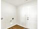 Clean laundry room features wood-look flooring, white door and washer/dryer hookups at 19599 Atwater Ave, Sheridan, IN 46069